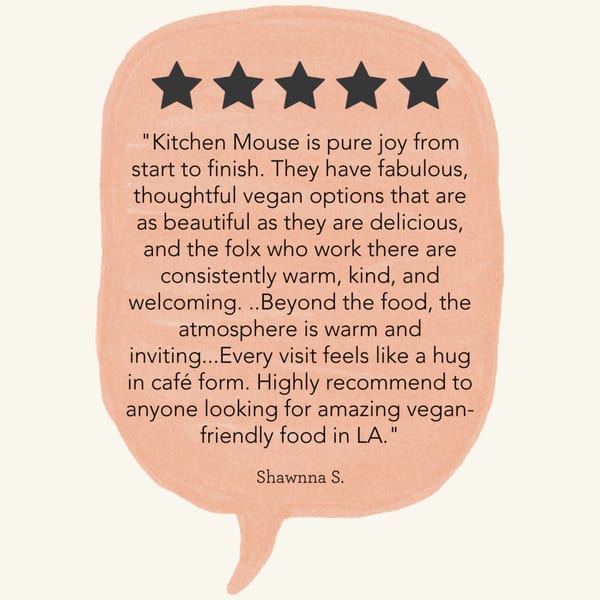 A five-star review for Kitchen Mouse, praising its vegan options, warm staff, and inviting atmosphere.